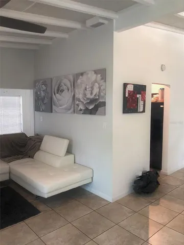 a living room with furniture and painting on the wall