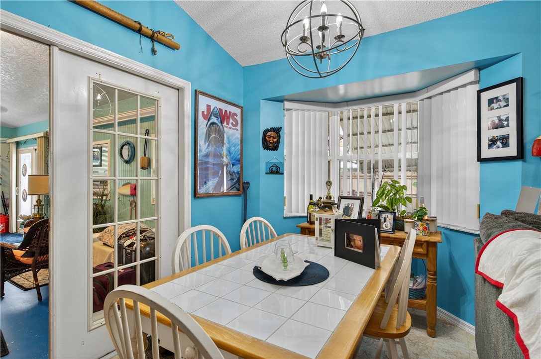1361 Clearbrook Street Sebastian, FL 32958 - Photo 13 of 29 a view of a dining room with furniture window and wooden floor
