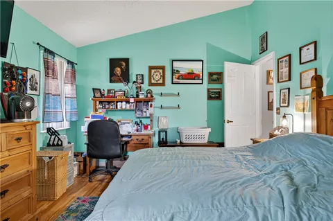 a bedroom with furniture and a wooden floor
