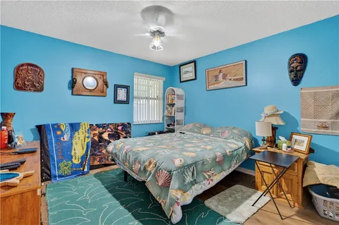 a bedroom with a bed and a desk