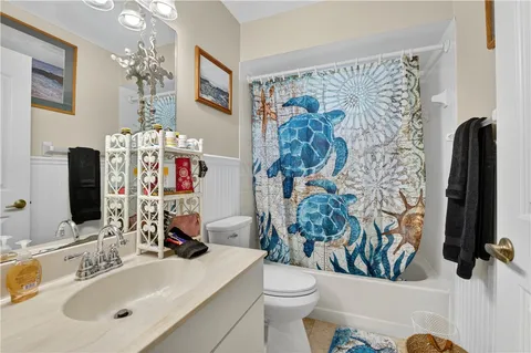 a bathroom with a sink mirror vanity and toilet