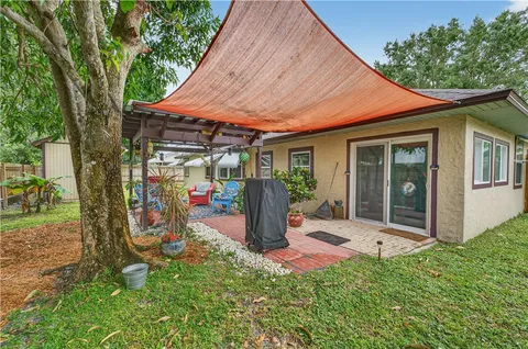 a view of a patio with table and chairs under an umbrella