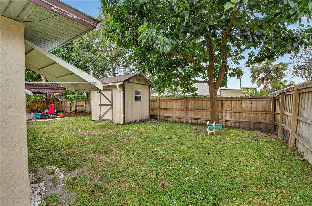 1361 Clearbrook Street Sebastian, FL 32958 - Photo 28 of 29 a view of a backyard with a small cabin and chair