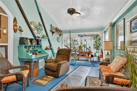 a living room with furniture rug and a large window