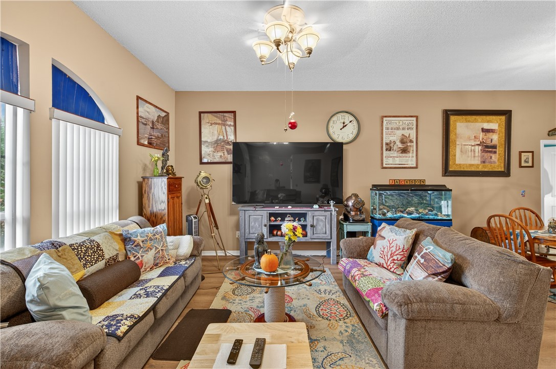 1361 Clearbrook Street Sebastian, FL 32958 - Photo 7 of 29 a living room with furniture and a flat screen tv
