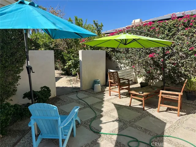 a view of a pathway with a flower garden
