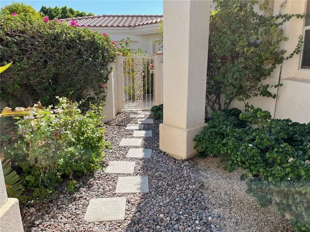 a living room with furniture plant and a window
