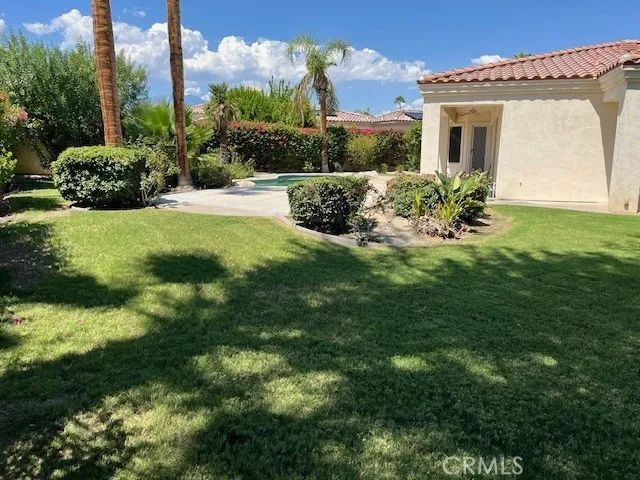a view of backyard with a garden and seating area