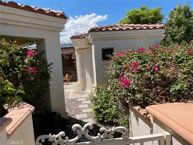 a couple of blue chairs sitting in a backyard