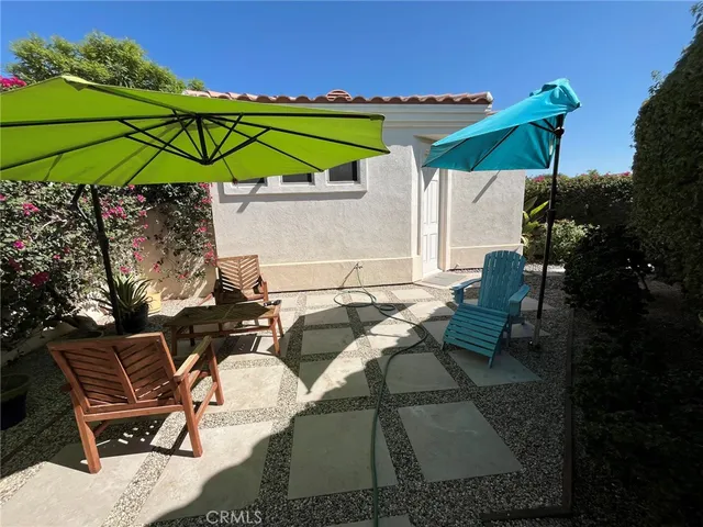 a patio with a patio table and chairs