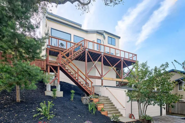 a view of a house with wooden deck