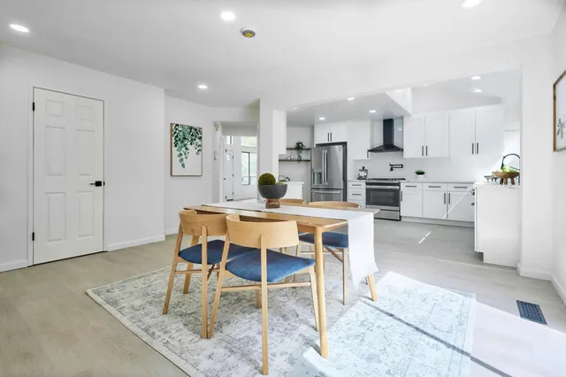 a dining room with kitchen island a table and chairs