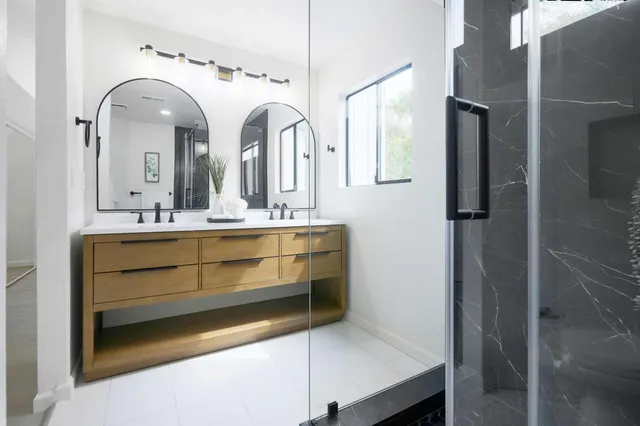 a bathroom with a double vanity sink and a mirror