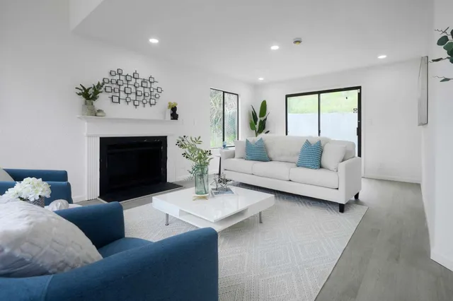 a living room with furniture and a fireplace