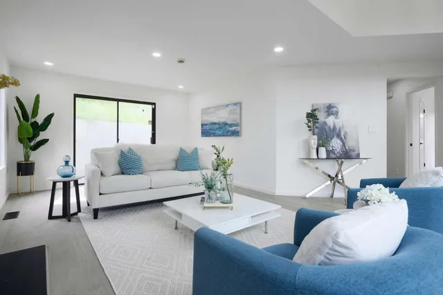 a living room with furniture and a large window