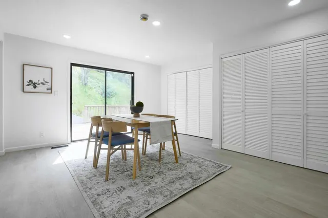 a view of a dining room with furniture and a window