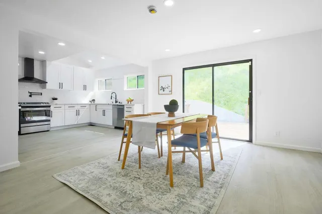 a view of a dining room with furniture and a large window