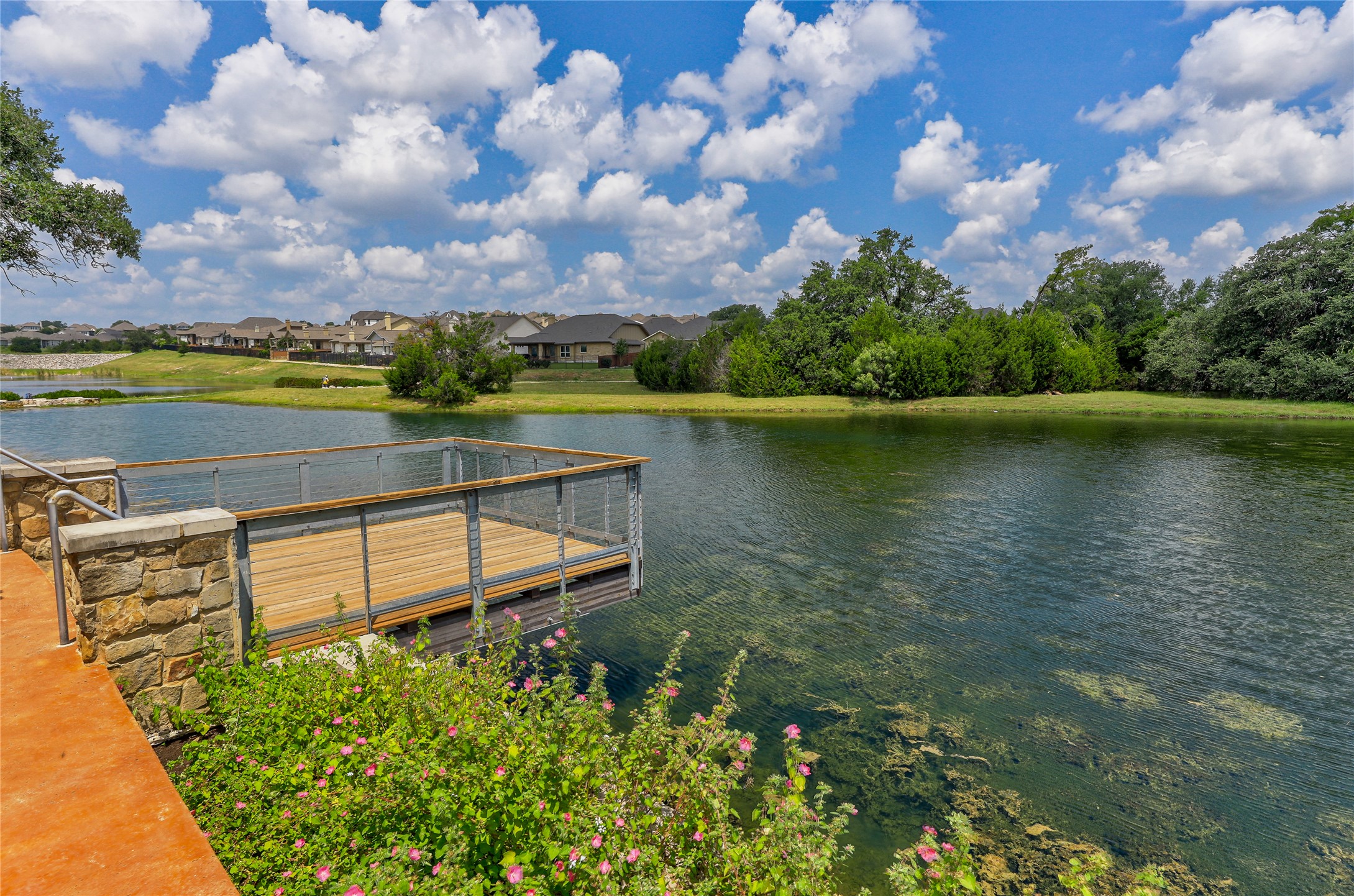 309 Rancho Sienna Loop Georgetown, TX 78628 - Photo 39 of 40 a view of a lake with a house in the background