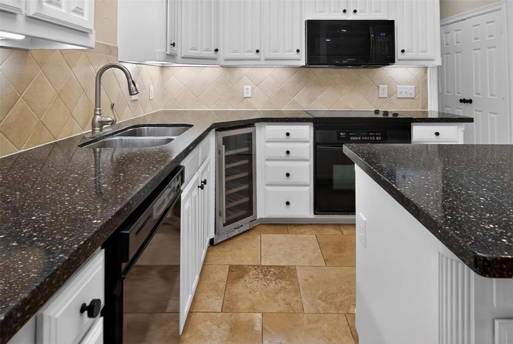 2122 Clear Lake Road Weatherford, TX 76087 - Photo 2 of 31 a kitchen with granite countertop a sink a stove and cabinets