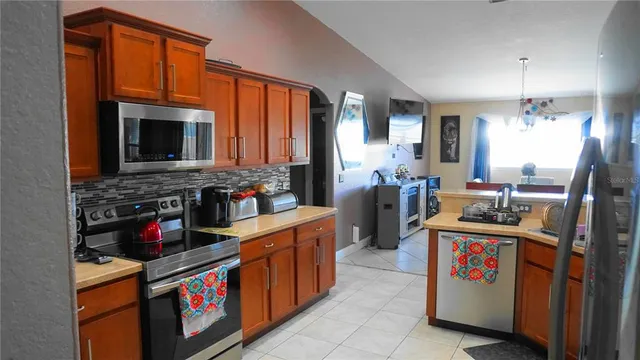 a kitchen with stainless steel appliances granite countertop a stove and cabinets