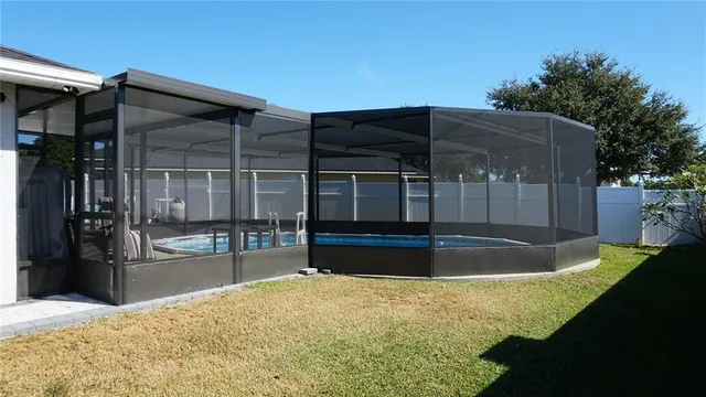 a view of a house with backyard and sitting area