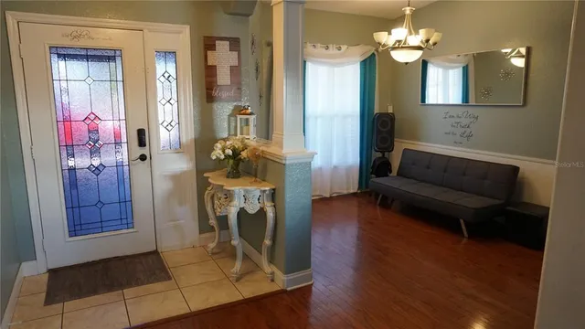 a view of a livingroom with furniture and a chandelier fan