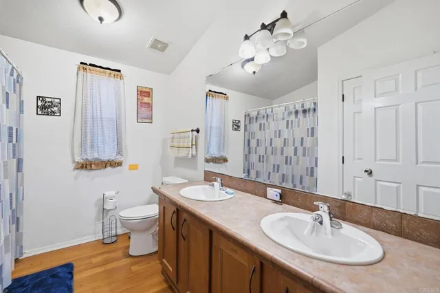 a bathroom with a sink a double vanity and a mirror