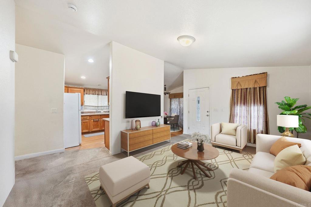 10767 Jamacha Boulevard, Unit SPC 119 Spring Valley, CA 91978 - Photo 4 of 25 a living room with furniture and a flat screen tv