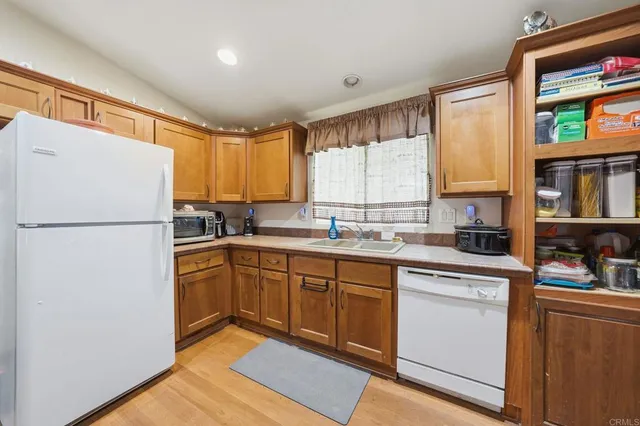 a kitchen with a refrigerator a sink and cabinets