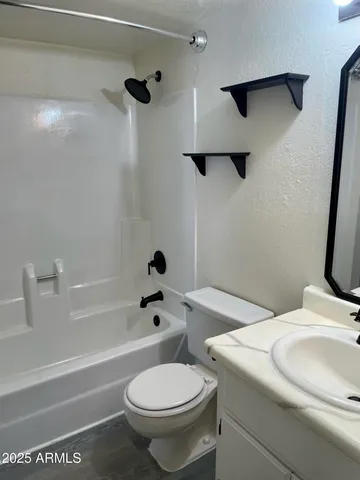 a utility room with cabinets washer and dryer