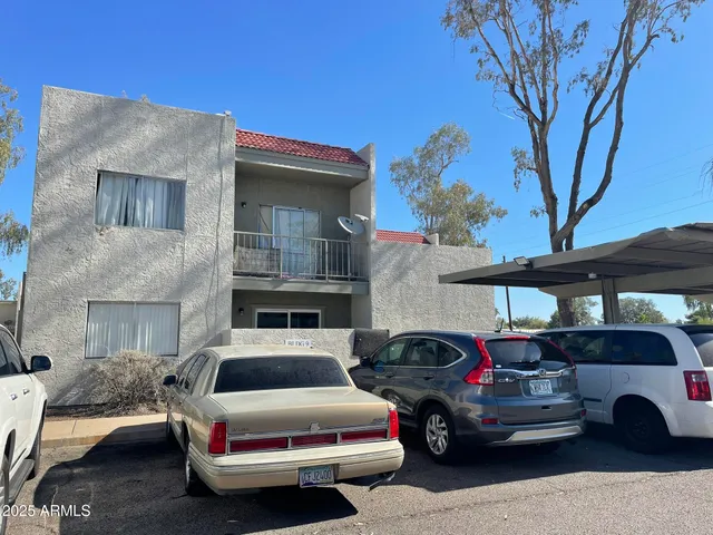 a couple of cars parked in front of a house