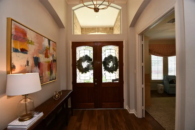 a view of hallway with a large window and wooden floor