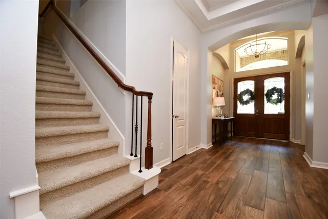 a view of an entryway with wooden floor and door