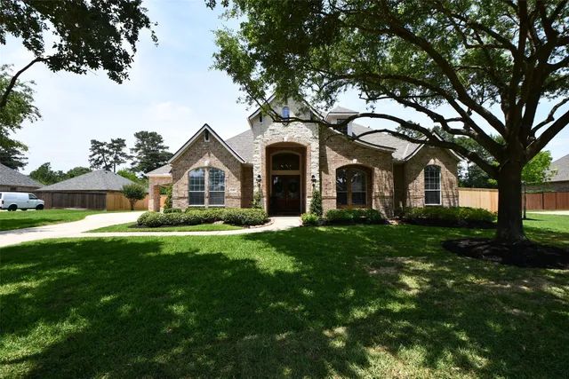 a front view of a house with a garden and yard