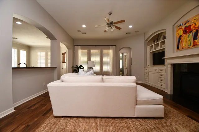 a white house with kitchen island and stainless steel appliances