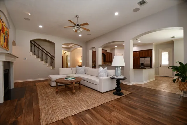 a living room with furniture and a wooden floor