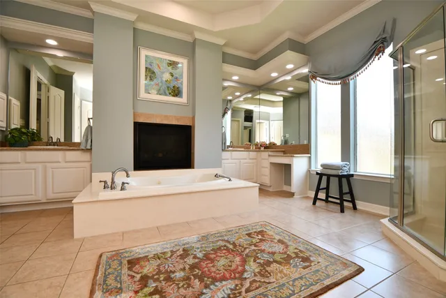 a spacious bathroom with a tub sink and a mirror