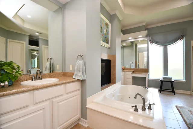 a bathroom with a tub sink and mirror