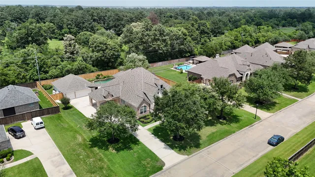 an aerial view of a house with garden space and street view