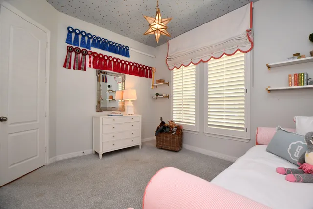 a bedroom with furniture and a window