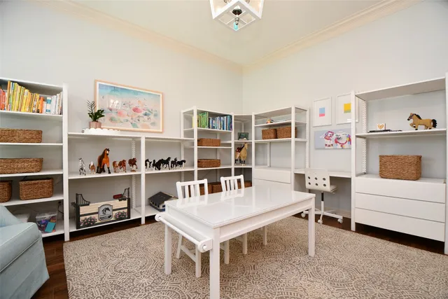 a living room with furniture and a book shelf