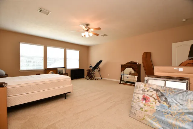 a bedroom with furniture and a large window