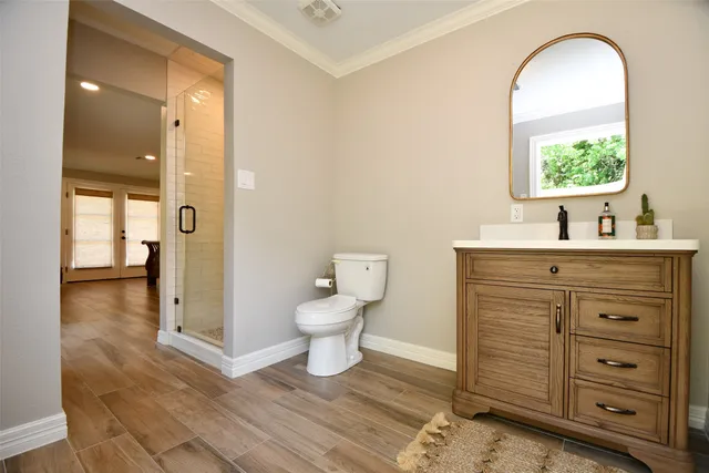 a bathroom with a sink a toilet and a mirror