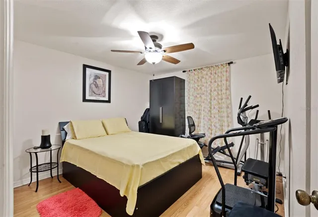 a bedroom with a bed a desk and chair