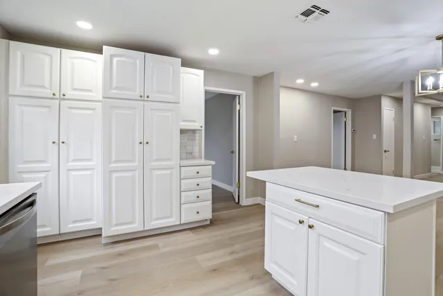 a kitchen with white cabinets