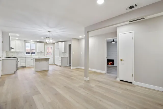 a view of a kitchen with a sink and a refrigerator