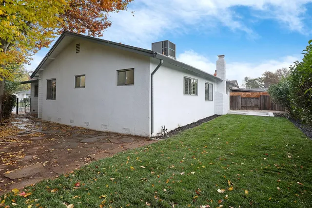 a view of backyard of house with green space