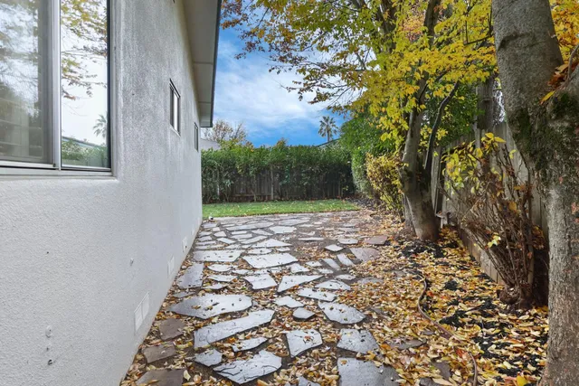 a view of a pathway both side of the house
