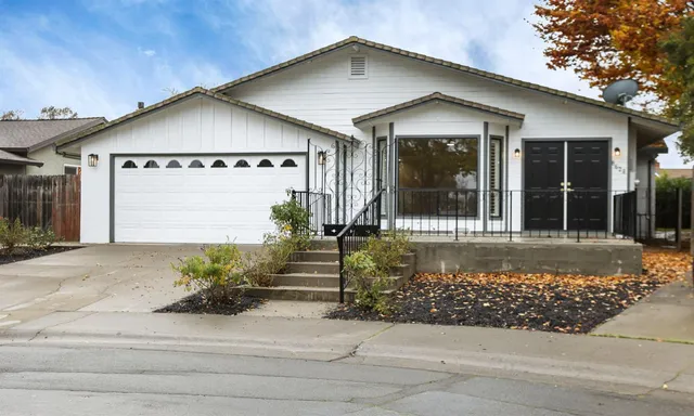 a front view of a house with a garden