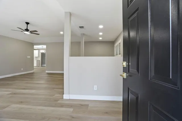 an empty room with wooden floor